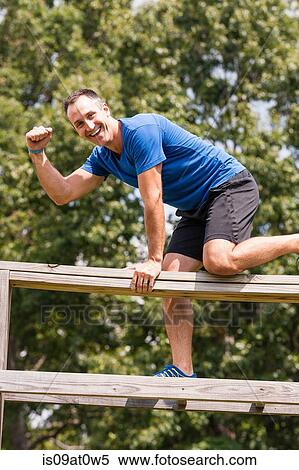 Mid adult man, working out, outdoors View Large Photo Image Stock Photography - Mid adult man, working out, outdoors. Fotosearch