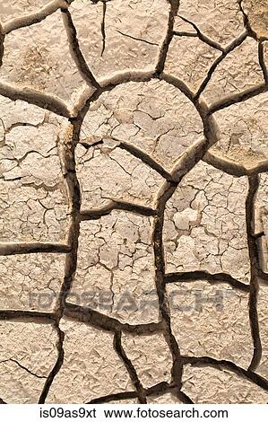 Stock Photograph - Overhead close up of dried cracked mud on floodplain, Djoudj National Park, Senegal. Fotosearch
