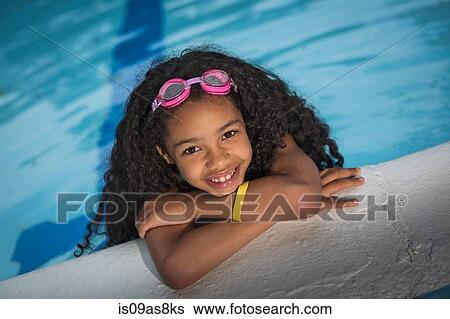 Portrait of girl with curly black hair hanging on edge of swimming pool, looking at camera smiling View Large Photo Image Stock Photograph - Portrait of girl with curly black hair hanging on edge of swimming pool, looking at camera smiling. Fotosearch