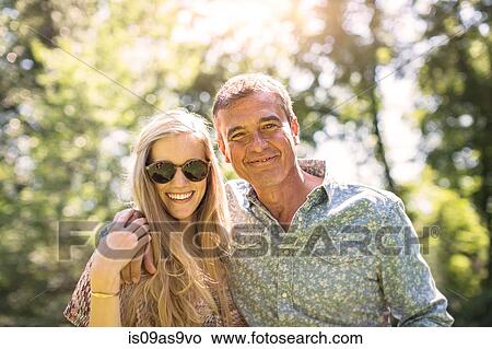 Picture - Portrait of mature man and girlfriend in garden. Fotosearch