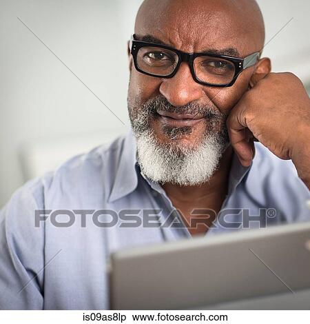 Portrait of mature man with greying beard and glasses, looking at camera smiling View Large Photo Image Stock Photography - Portrait of mature man with greying beard and glasses, looking at camera smiling. Fotosearch