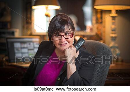 Portrait of senior woman in office, using telephone View Large Photo Image Stock Image - Portrait of senior woman in office, using telephone. Fotosearch