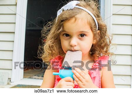 Portrait of young girl, eating ice lolly View Large Photo Image Stock Image - Portrait of young girl, eating ice lolly. Fotosearch