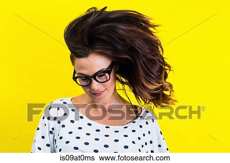 Portrait of young woman flicking hair View Large Photo Image Stock Photograph - Portrait of young woman flicking hair. Fotosearch
