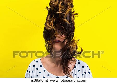 Portrait of young woman flicking hair View Large Photo Image Stock Photograph - Portrait of young woman flicking hair. Fotosearch