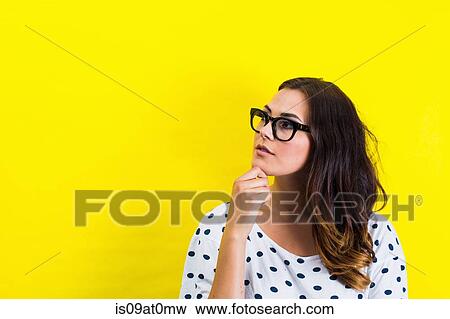 Portrait of young woman, hand on chin in thoughtful pose View Large Photo Image Stock Photo - Portrait of young woman, hand on chin in thoughtful pose. Fotosearch