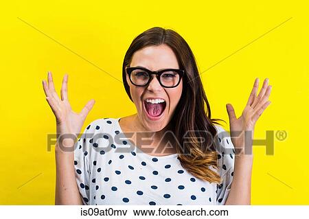 Portrait of young woman with eyeglasses, screaming View Large Photo Image Stock Photo - Portrait of young woman with eyeglasses, screaming. Fotosearch