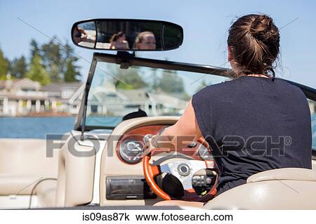 Rear view of young woman driving motor boat, Lake Oswego, Oregon, USA View Large Photo Image Stock Image - Rear view of young woman driving motor boat, Lake Oswego, Oregon, USA. Fotosearch