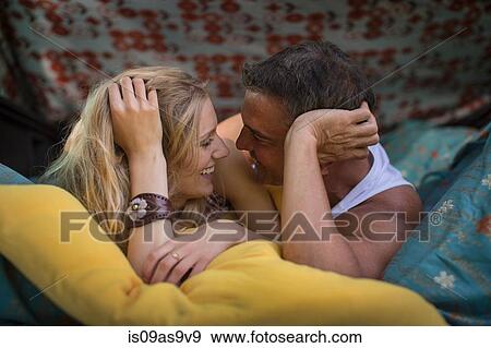 Romantic couple lying in pick up boot whilst camping View Large Photo Image Stock Photo - Romantic couple lying in pick up boot whilst camping. Fotosearch