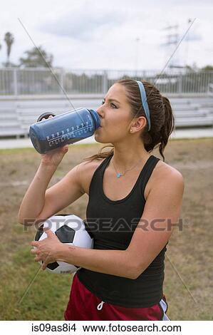 Soccer player drinking in field View Large Photo Image Picture - Soccer player drinking in field. Fotosearch