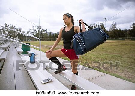 Soccer player placing sports bag on bench View Large Photo Image Stock Image - Soccer player placing sports bag on bench. Fotosearch