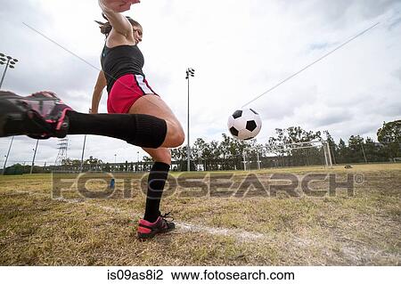 Stock Image - Soccer player practising in field. Fotosearch