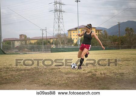 Soccer player practising in field View Large Photo Image Stock Photo - Soccer player practising in field. Fotosearch