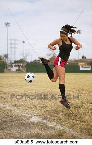 Stock Photography - Soccer player practising in field. Fotosearch
