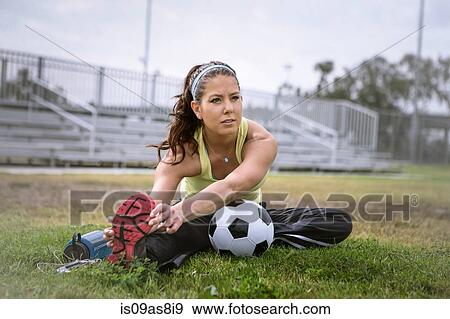 Stock Photo - Soccer player stretching in field. Fotosearch
