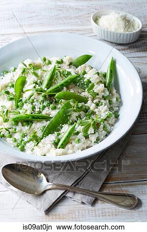Picture - Still life of pea risotto with parmesan cheese and pepper. Fotosearch