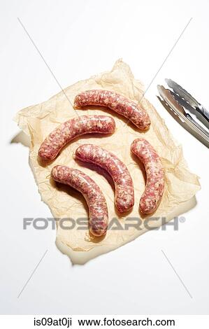 Stock Image - Still life of raw italian sausages on brown paper. Fotosearch