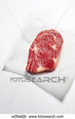 Still life of raw rib-eye steak on greaseproof paper View Large Photo Image Stock Image - Still life of raw rib-eye steak on greaseproof paper. Fotosearch
