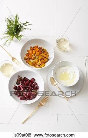 Still life of roasted golden and red beets with pine, served with olive oil yogurt View Large Photo Image Stock Photo - Still life of roasted golden and red beets with pine, served with olive oil yogurt. Fotosearch