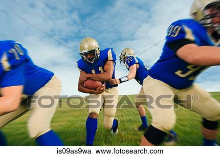 Team of teenage American football players practicing on playing field View Large Photo Image Stock Image - Team of teenage American football players practicing on playing field. Fotosearch