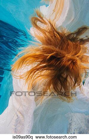 Young red headed woman underwater, overhead view View Large Photo Image Stock Photography - Young red headed woman underwater, overhead view. Fotosearch