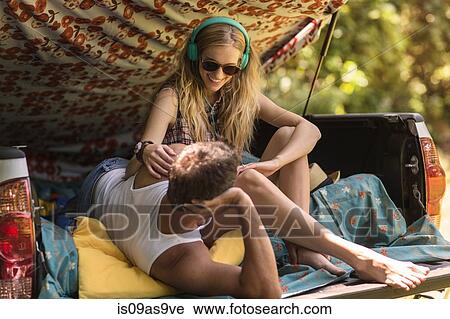 Young woman and boyfriend in pick up boot whilst camping View Large Photo Image Stock Image - Young woman and boyfriend in pick up boot whilst camping. Fotosearch