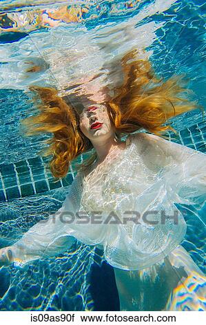 Young woman underwater, wearing thin white shirt View Large Photo Image Stock Image - Young woman underwater, wearing thin white shirt. Fotosearch