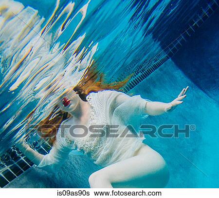 Young woman underwater, wearing thin white shirt View Large Photo Image Stock Photograph - Young woman underwater, wearing thin white shirt. Fotosearch