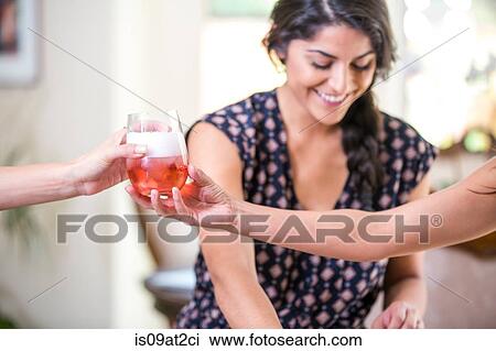 Adult sisters in kitchen handing glass of rose wine View Large Photo Image Stock Image - Adult sisters in kitchen handing glass of rose wine. Fotosearch