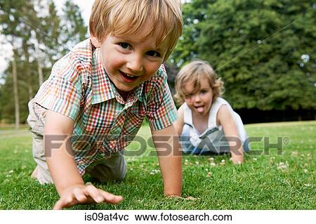 "Boy and girl on grass crawling on hands and knees, looking at camera smiling" View Large Photo Image Stock Image - "Boy and girl on grass crawling on hands and knees, looking at camera smiling". Fotosearch