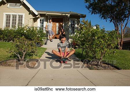 Boy skateboarding down garden path View Large Photo Image Stock Image - Boy skateboarding down garden path. Fotosearch