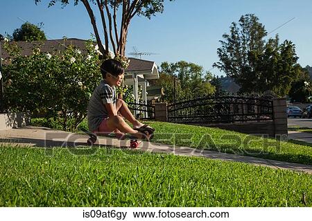 Boy skateboarding down garden View Large Photo Image Stock Photo - Boy skateboarding down garden. Fotosearch