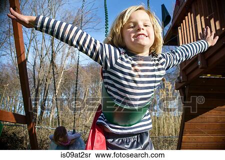 Stock Photography - Boy with red cape pretending to fly. Fotosearch