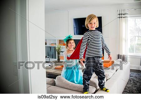 Children in costumes playing on sofa View Large Photo Image Stock Photo - Children in costumes playing on sofa. Fotosearch