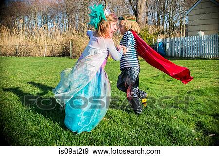 Stock Photo - Children in costumes playing outdoors. Fotosearch