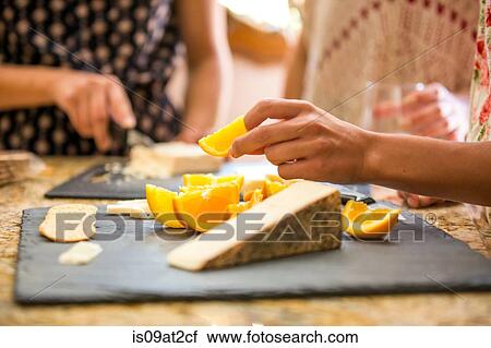 Close up of three adult sisters snacking from cheese board View Large Photo Image Stock Image - Close up of three adult sisters snacking from cheese board. Fotosearch