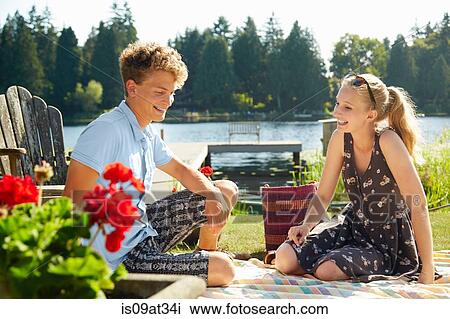 Stock Image - "Couple enjoying lake party, Seattle, Washington, USA". Fotosearch