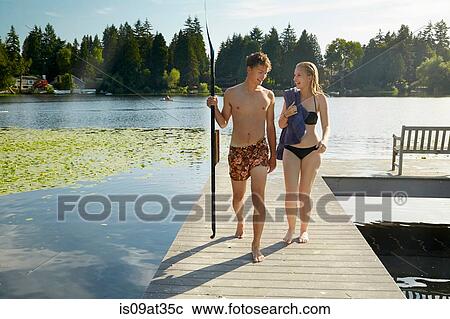Stock Image - "Couple leaving lake after swim, Seattle, Washington, USA". Fotosearch