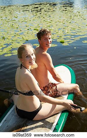 "Couple paddling boat in lake, Seattle, Washington, USA" View Large Photo Image Stock Photo - "Couple paddling boat in lake, Seattle, Washington, USA". Fotosearch