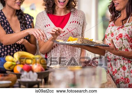 Cropped shot of three adult sisters snacking from cheese board View Large Photo Image Stock Image - Cropped shot of three adult sisters snacking from cheese board. Fotosearch