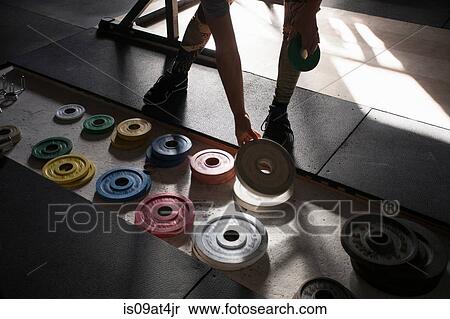 Crossfitter choosing weight plate View Large Photo Image Stock Photography - Crossfitter choosing weight plate. Fotosearch