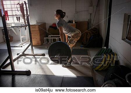 Crossfitter lifting barbell in gym View Large Photo Image Stock Photograph - Crossfitter lifting barbell in gym. Fotosearch