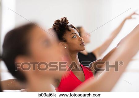 "Dancers in ballet position, arms raised looking up" View Large Photo Image Stock Image - "Dancers in ballet position, arms raised looking up". Fotosearch