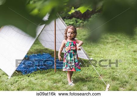 Distracted girl playing with string on homemade garden tent View Large Photo Image Stock Image - Distracted girl playing with string on homemade garden tent. Fotosearch