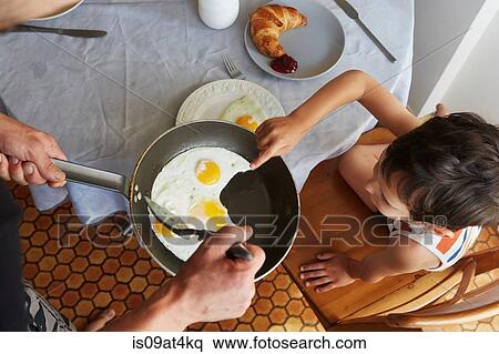 Father and son having breakfast View Large Photo Image Stock Photography - Father and son having breakfast. Fotosearch