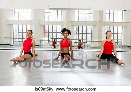 Front view of young women in dance studio side by side doing the splits View Large Photo Image Stock Photo - Front view of young women in dance studio side by side doing the splits. Fotosearch