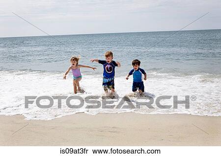 Girl and boys running and slashing in sea View Large Photo Image Stock Photography - Girl and boys running and slashing in sea. Fotosearch