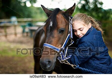 Girl horseback rider hugging horse View Large Photo Image Stock Image - Girl horseback rider hugging horse. Fotosearch