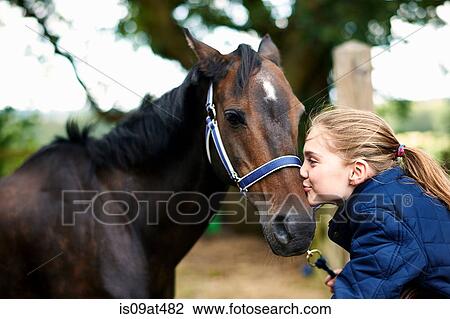 Girl horseback rider kissing horse View Large Photo Image Stock Image - Girl horseback rider kissing horse. Fotosearch