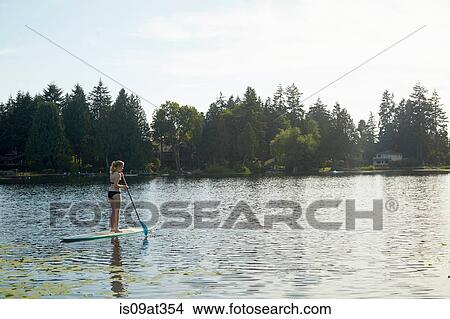 "Girl paddling boat in lake, Seattle, Washington, USA" View Large Photo Image Picture - "Girl paddling boat in lake, Seattle, Washington, USA". Fotosearch